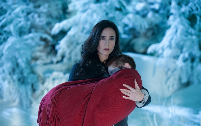 Jennifer Connelly carrying a child in a snowy forest