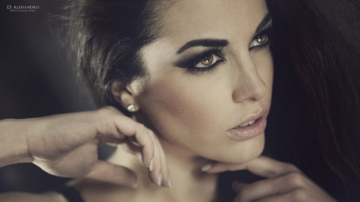 Woman with dark hair and dramatic makeup