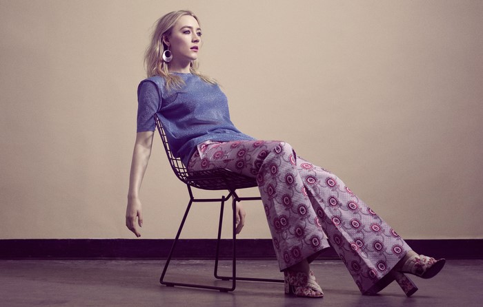 Saoirse Ronan sitting on a chair