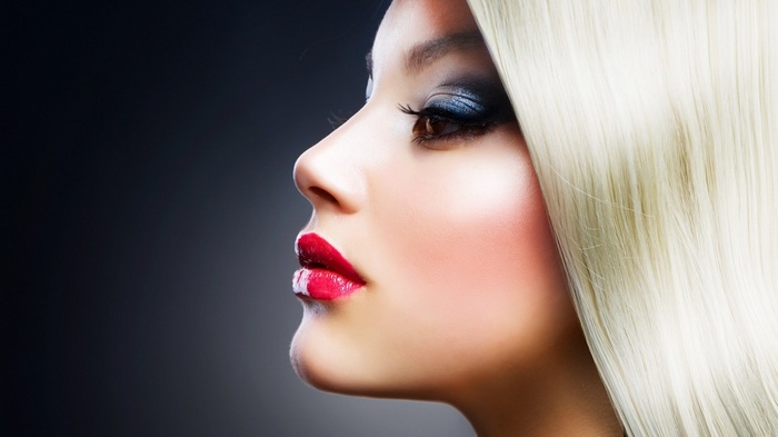 Woman with blonde hair and dramatic makeup