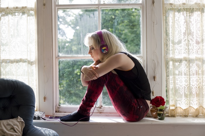 Saoirse Ronan listening to music by the window