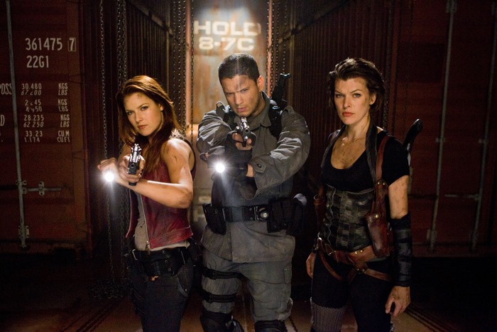 Ali Larter and two men with guns