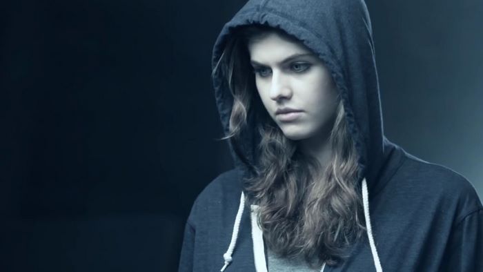 Alexandra Daddario in Dark Hoodie with Pensive Expression