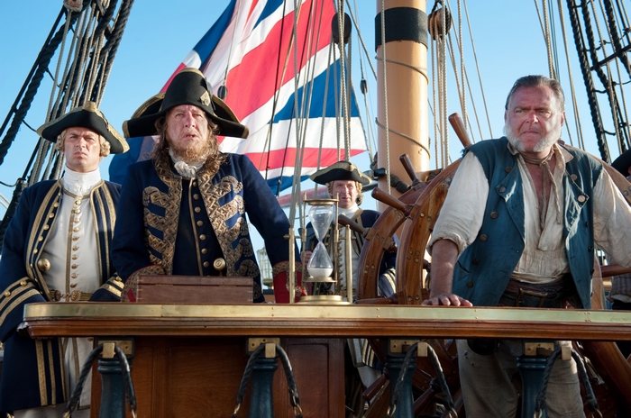 Geoffrey Rush and other men on a ship