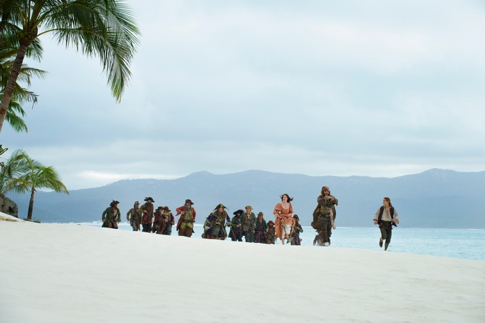 Geoffrey Rush and pirates on a beach