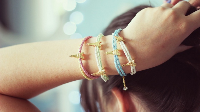 Bracelets with Eiffel Tower charms on a woman's arm