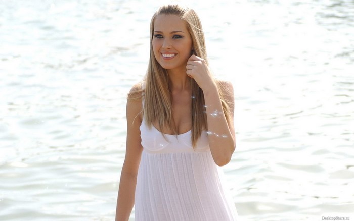 Petra Nemcova in white dress by the water