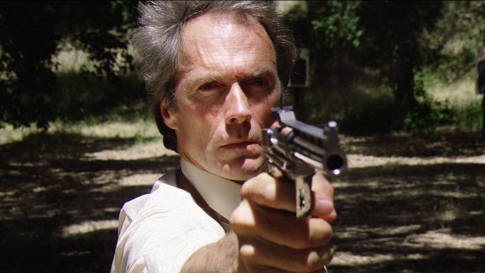 Clint Eastwood aiming a handgun
