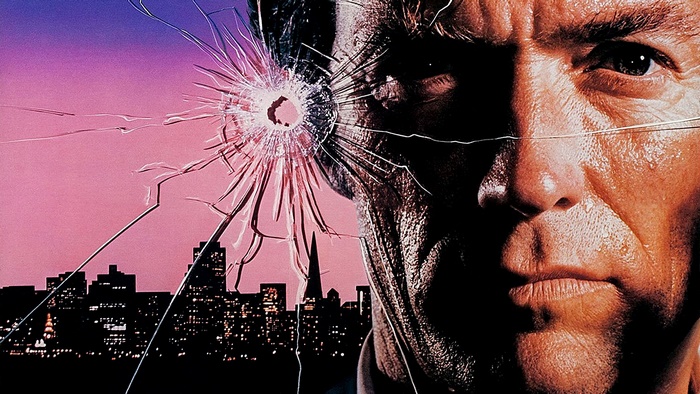 Clint Eastwood through broken glass with city skyline