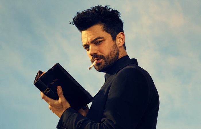 Dominic Cooper holding a Bible and smoking