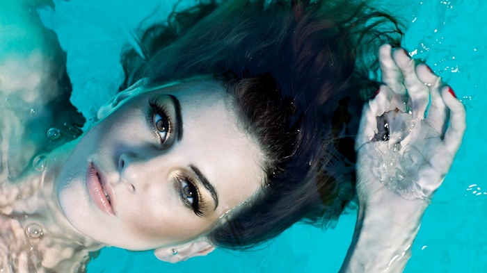 Woman floating in turquoise water