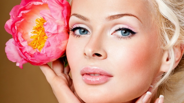 Woman with pink peony flower