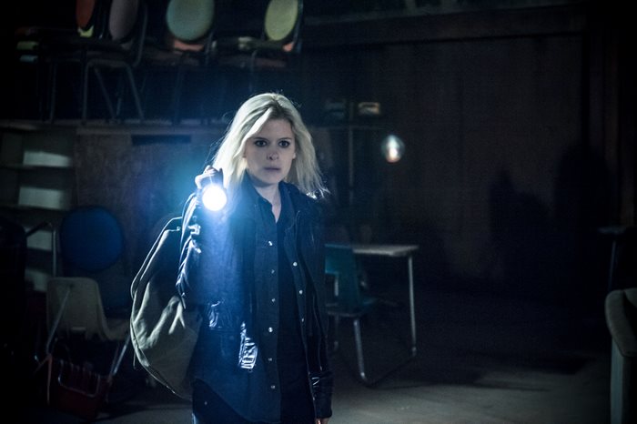 Kate Mara holding a flashlight