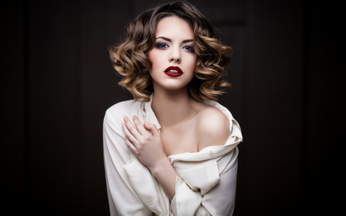 Woman with curly hair and red lipstick
