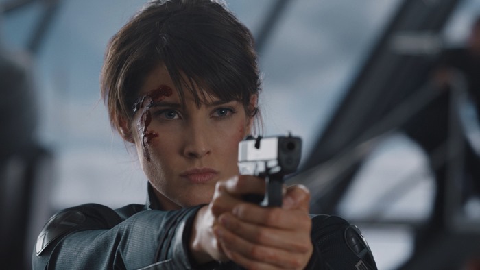 Maria Hill from The Avengers holding a gun