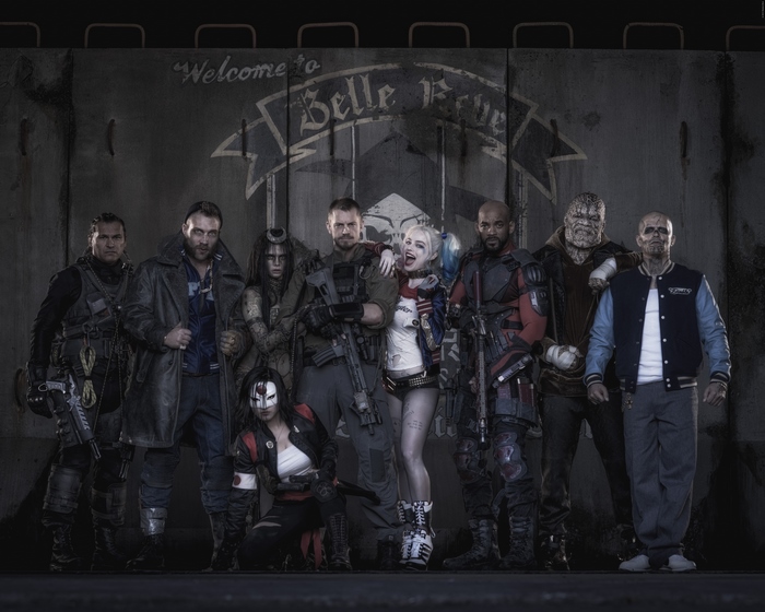 Suicide Squad characters in front of Belle Reve wall