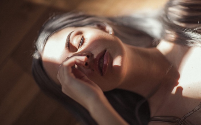 Woman lying down with sunlight on her face