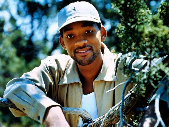 Will Smith in a tan jacket and baseball cap
