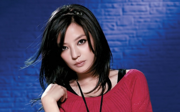 Woman with black hair wearing a red sweater