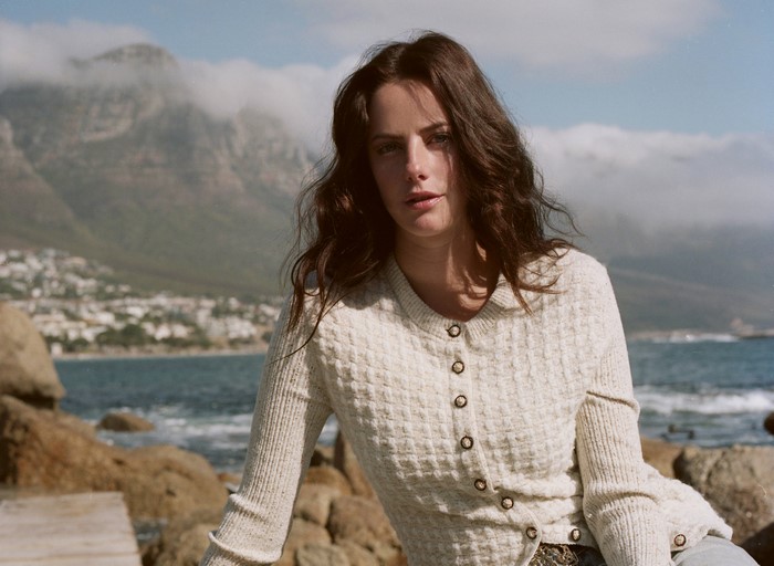 Kaya Scodelario on a rocky coast
