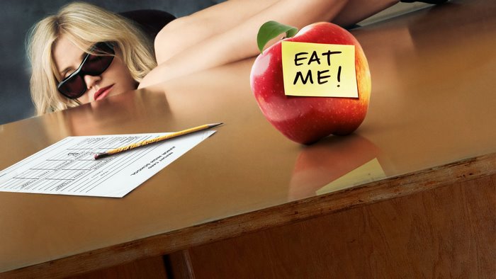 Cameron Diaz on a desk with an apple