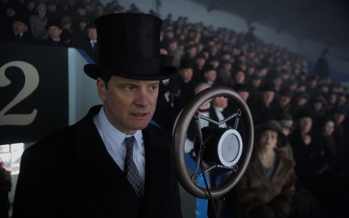 Colin Firth speaking into a microphone