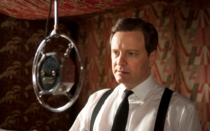 Colin Firth in front of a microphone