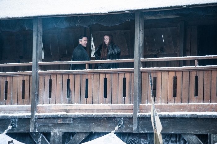 Aidan Gillen and Sophie Turner on a wooden balcony