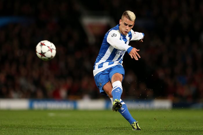 Antoine Griezmann kicking a soccer ball
