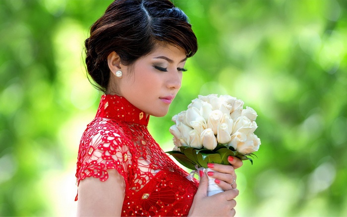 Woman in red dress holding white roses