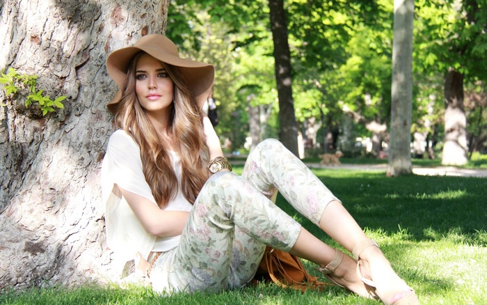 Woman in Hat and Floral Pants in Park
