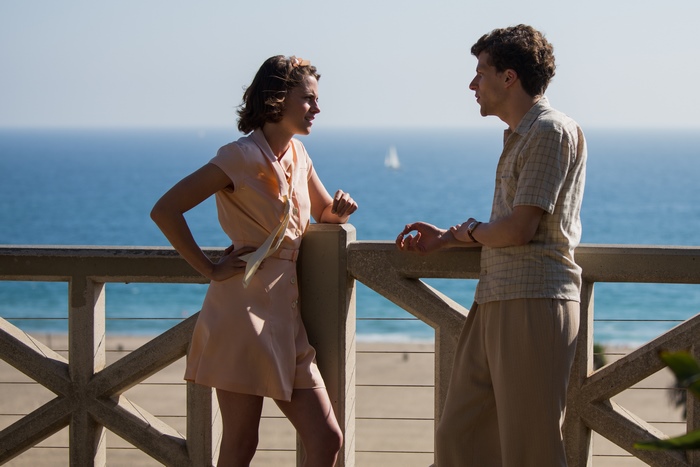 Jesse Eisenberg and woman on balcony