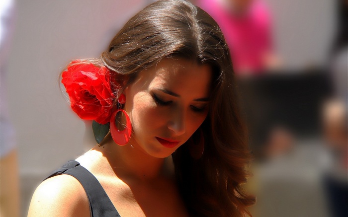 Woman with red flower and earrings