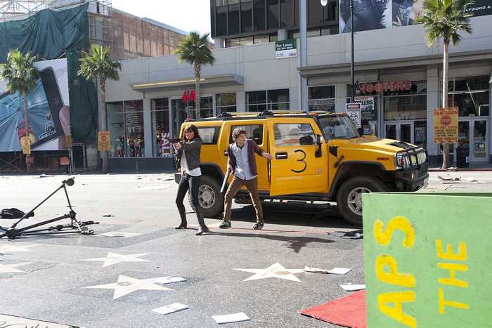Jesse Eisenberg and Isla Fisher in a yellow Hummer