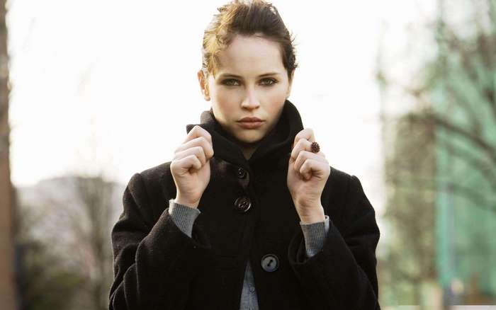 Felicity Jones in a black coat