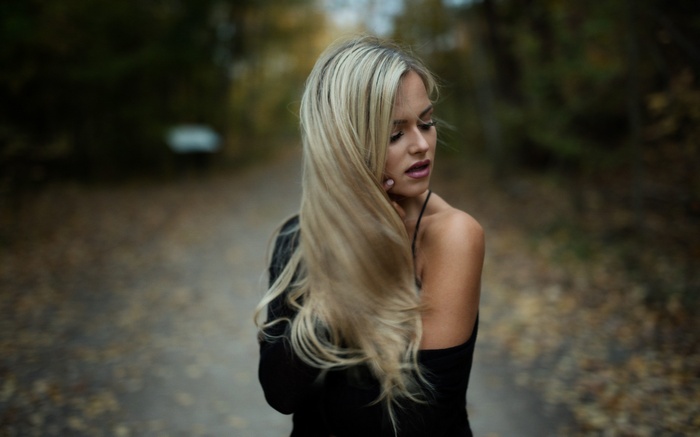 Woman with blonde hair in a black dress