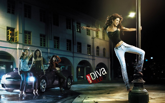 Four women having fun at night near a car