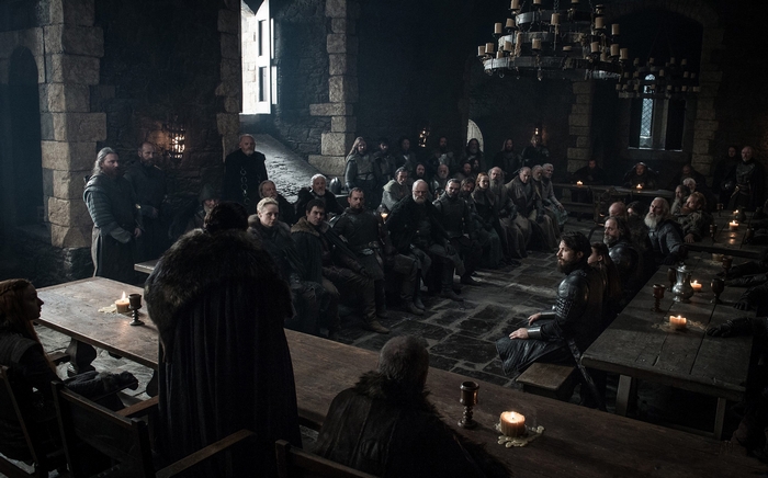 Liam Cunningham and others in a hall