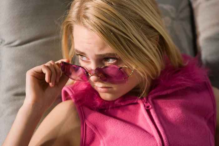 AnnaSophia Robb wearing pink vest and sunglasses