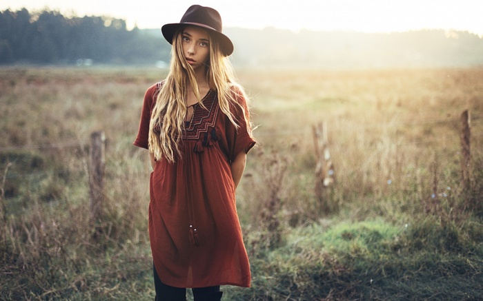 Woman in hat and dress in a field