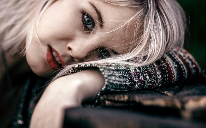 Woman with blonde hair resting her head