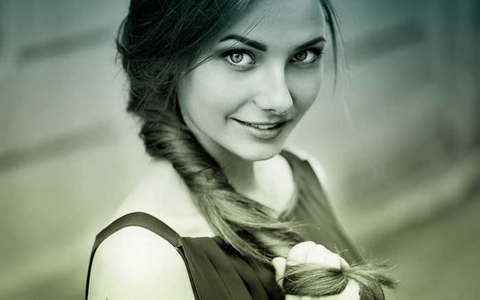 Woman with braided hair holding her hair