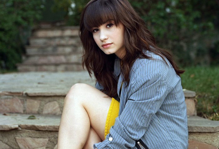 Demi Lovato sitting on stone steps