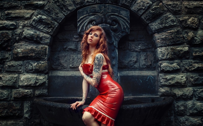 Woman in red dress with tattoos