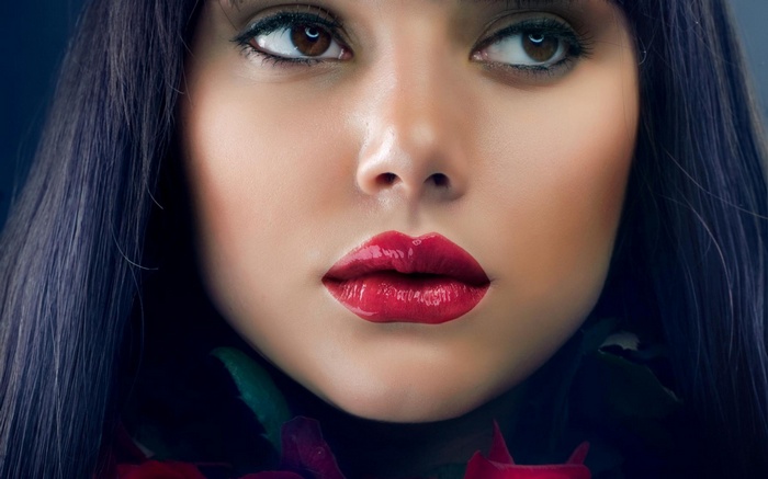 Close-up of a woman's face with red lipstick