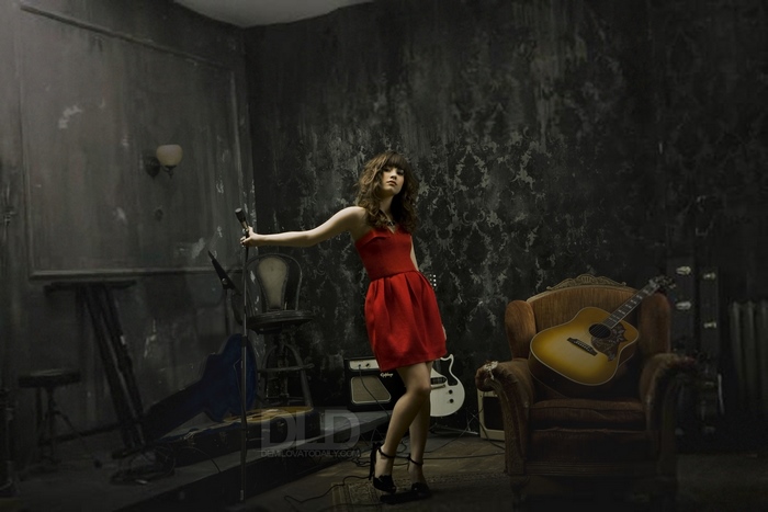 Demi Lovato in a red dress with guitars and microphone