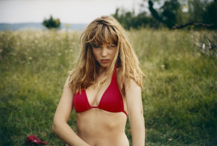 Léa Seydoux in a red bikini in a field