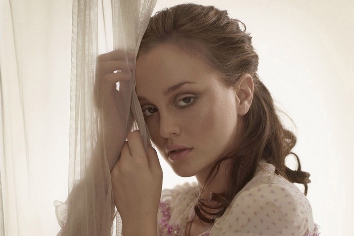 Leighton Meester posing behind a sheer curtain