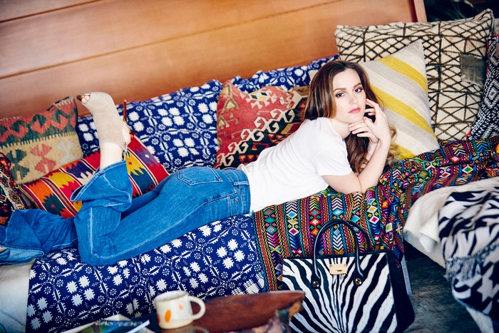 Leighton Meester on a couch with pillows