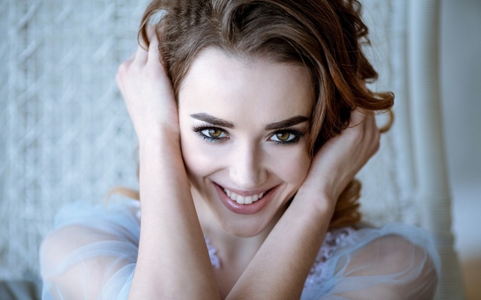Woman with hands in hair smiling